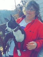 Barb holding Knox watching Dylan play