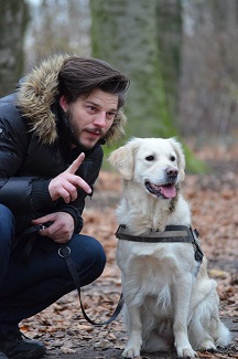 Man squatting down to talk to his dog