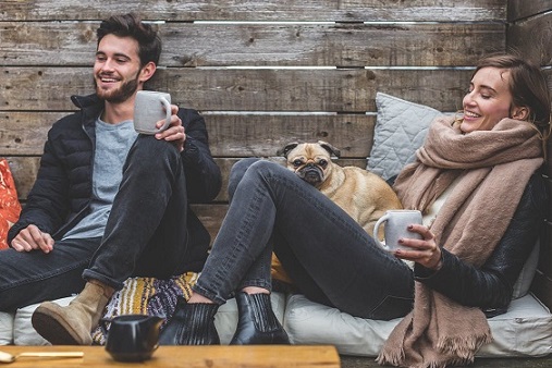 Young couple relaxing with their dog